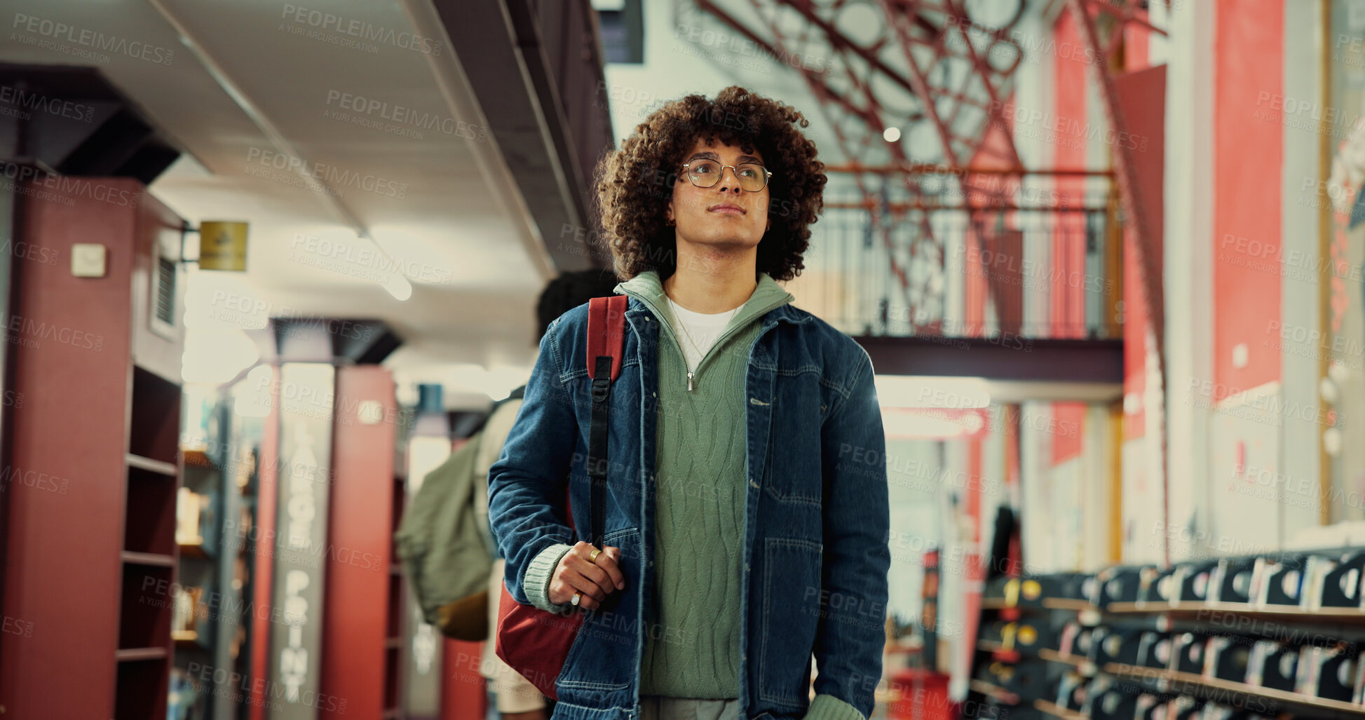 Buy stock photo Walking, student and thinking with man in library for reflection, university project or study resources. College vision, scholarship opportunity and knowledge with person on campus for school course