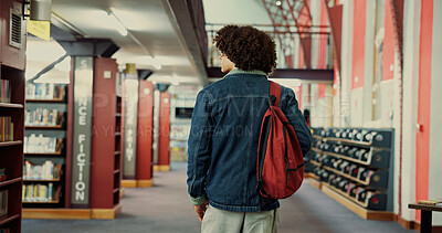 Buy stock photo Walking, research and back of man in library for learning, university project or study resources. College thesis, scholarship opportunity and knowledge with student on education campus with backpack