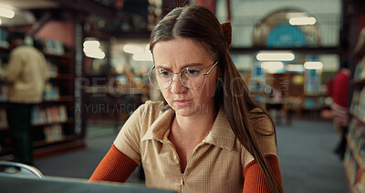 Buy stock photo Student, serious woman and computer in library for learning, education or problem solving in college. University, technology and girl on internet to research thesis, studying knowledge or scholarship