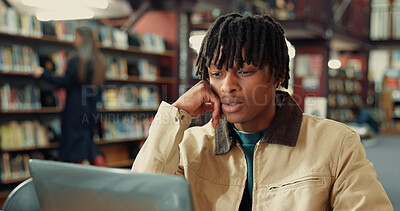 Buy stock photo Student, man and laptop in library for college studying, research and thinking for learning resource. Serious, confused and person reading online for university education, knowledge or scholarship