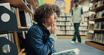 Library, student and reading book with thinking for education, research and knowledge in college. University, male person and man with studying for thesis, literature and learning with ideas for test