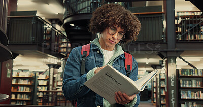 Buy stock photo Library, man and student with reading book for studying, assignment information and exam on campus. College, male person and glasses with english literature for education, learning and novel for test