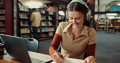 Buy stock photo University, headphones and woman on laptop in library for online assignment, studying and test. College, happy and student with music on computer for research notes, education and learning on campus