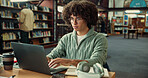 Student, laptop and typing in library with man for studying, assignment or thesis on college campus. Computer, writing and male person with education, preparation for exam or research for paper