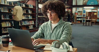 Buy stock photo Student, laptop and typing in library with man for studying, assignment or thesis on college campus. Computer, writing and male person with education, preparation for exam or research for paper