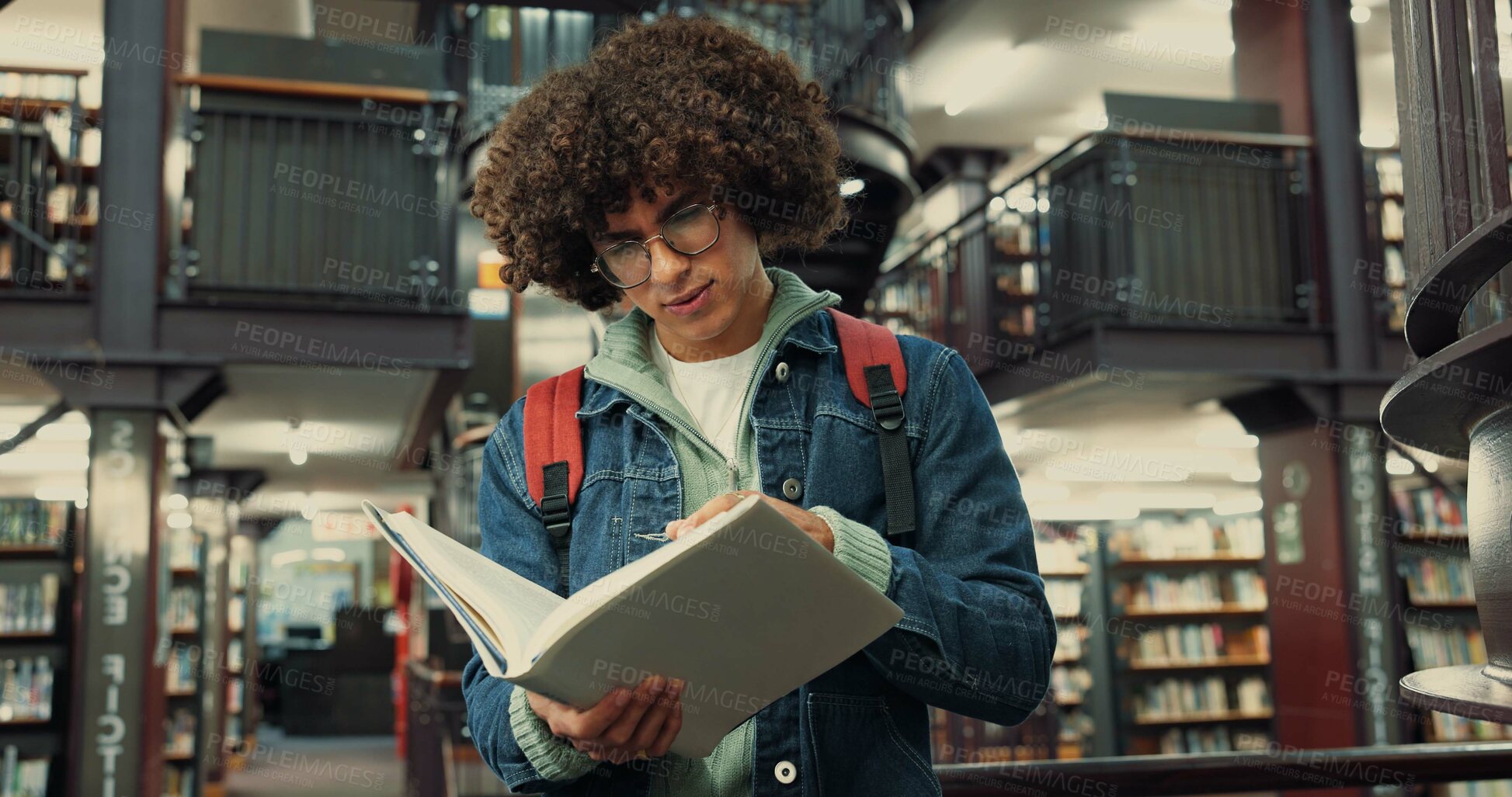 Buy stock photo Library, man and student with reading book for learning, assignment information and exam on campus. College, male person and glasses with english literature for education, studying and novel for test