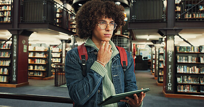 Buy stock photo Thinking, student and man with tablet, library and preparing for exam with research and scholarship. Serious, learner and person with tech to study, knowledge and reflection for test, online or space