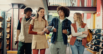 Buy stock photo People, students and walking with books in library of education, research project and study. Smile, group and friends talking with textbooks, learning advice and scholarship offer of exam preparation