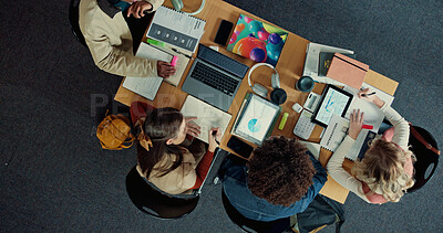 Buy stock photo Technology, books and group of students studying in library for university test, project or exam. Top view, notes and friends preparing for college assignment together with scholarship at campus.