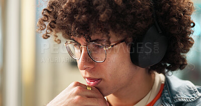 Buy stock photo Thinking, student and man with headphones for project, learning and studying for school test. University, college and thoughtful person with glasses listening to music, audio or podcast for education