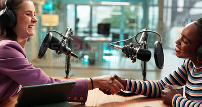 Buy stock photo Podcast interview, host or guest with handshake in studio for welcome, talk show or radio broadcast. Media production, content creation and happy women with shaking hands for greeting and live stream