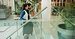 Luggage, stairs and travel with business people in hotel for conference event, guest check in and arrival. Convention venue, suitcase and steps with man and woman in lobby for hospitality and expo