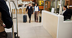 Hotel, luggage and people in lobby, blur and business with checkout, service and guests. Travel agency, global traders and export with hospitality, reception and suitcase with trip and talking