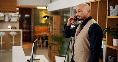 Buy stock photo Man, phone call and talk at hotel, concierge and happy with clerk for booking information. Person, help desk and receptionist with telephone, contact and listen with hospitality service at lodge