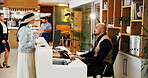 Man, woman and concierge with welcome at hotel reception with reservation, discussion or booking info. People, client and talk for accommodation, hospitality and suite at help desk in lobby at lodge