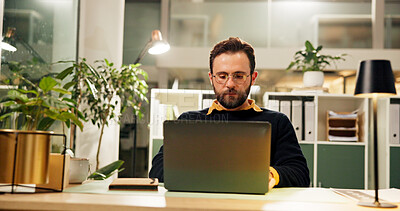 Buy stock photo Man, laptop and night at startup, typing and research for report, project and deadline in office. Person, editor and computer with reading, feedback or review process with overtime at creative agency