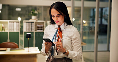 Business, woman and scroll with phone in office for night trading, reading economy news or trends. Happy, working late and trader with smartphone for online research, portfolio review and networking
