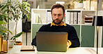 Man, laptop and night at office, typing and research for report, project and deadline in startup. Person, editor and computer with reading, feedback or review process with overtime at creative agency