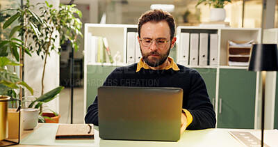 Buy stock photo Man, laptop and night at office, typing and research for report, project and deadline in startup. Person, editor and computer with reading, feedback or review process with overtime at creative agency