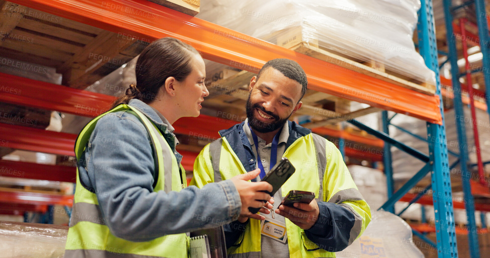 Buy stock photo Man, woman and phone at warehouse, storage or happy for logistics, talk or supply chain management. People, team and smartphone with smile for application, strategy and notification at shipping plant