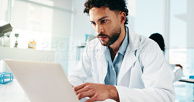 Buy stock photo Man, scientist and typing on laptop in lab for research, reading study and medical experiment. Serious, male person and online for project, biotechnology and science article of healthcare information