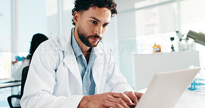 Buy stock photo Man, scientist and reading on laptop in lab for research, study results and medical experiment. Male person, typing and online for project, biotechnology and science article of healthcare information