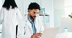 Serious, man and scientist on laptop in lab for research, reading study and medical experiment. Male person, typing and online for project, biotechnology and science article of healthcare information