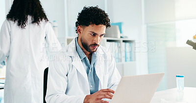 Buy stock photo Serious, man and scientist on laptop in lab for research, reading study and medical experiment. Male person, typing and online for project, biotechnology or science article for healthcare information