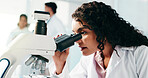 Microscope, woman and scientist in laboratory for study, research or analysis for medical breakthrough. Science, biotechnology and female biologist with pharmaceutical investigation for innovation.