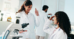 Science, women and high five with tablet in lab for breakthrough discovery, study success or goals. Scientists, teamwork and celebration for medical research and development of cancer immunotherapy