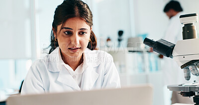 Buy stock photo Woman, scientist and reading on laptop in lab of research, study results and medical experiment. Female person, review or pc for project, biotechnology and discovery article of healthcare information