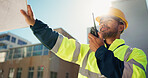 Engineer, radio and inspection with man on rooftop for property developer, architecture or feedback. Low angle, renovation and building contractor with person on construction site for progress report