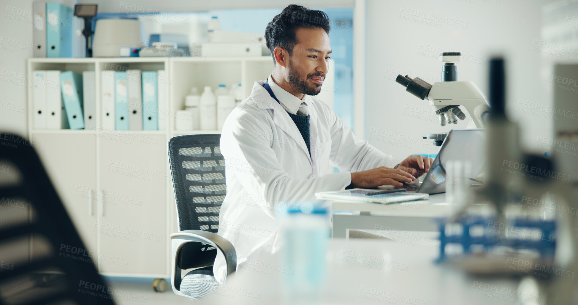 Buy stock photo Science, laptop and man typing in lab for medical research, medicine study and results. Healthcare, microscope and scientist on digital tech for vaccine report, innovation and biology experiment