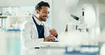Science, laptop and man with microscope in lab for medical research, medicine study and results. Healthcare, biology and scientist on digital tech for vaccine report, innovation and experiment