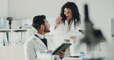 Buy stock photo Happy, scientist and high five with tablet for research, medical discovery or forensic science. Excited, man and woman with smile or technology for success, teamwork or winning together at laboratory
