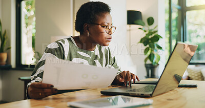 Buy stock photo Black woman, document and typing on laptop at house for accounting, finance report and remote work. Female freelancer, audit and online for financial results, stats paperwork and expenses information