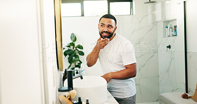 Buy stock photo Mirror, beauty and smile with man in bathroom for skincare, grooming and cosmetics. Morning routine, dermatology progress and facial benefits with person in home for glow, treatment and hydration