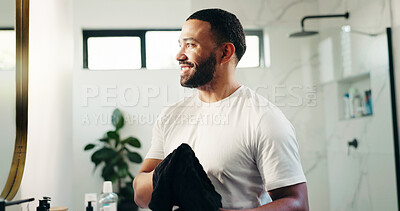 Buy stock photo Towel, beauty and smile with man in bathroom for skincare, grooming and cosmetics. Morning routine, dermatology progress and facial benefits with person in home for glow, treatment and hydration