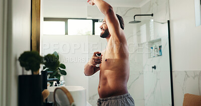Buy stock photo Hygiene, man and spray deodorant in bathroom for sweat control, odor protection and getting ready. Mirror, home and person with underarm antiperspirant for morning routine, fresh fragrance and scent