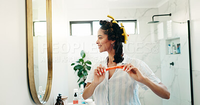 Buy stock photo Bathroom, woman and hair curlers in mirror for getting ready, morning routine or heatless hairstyle. Beauty, person and happy in home with haircare, grooming and pinup curls for self care maintenance