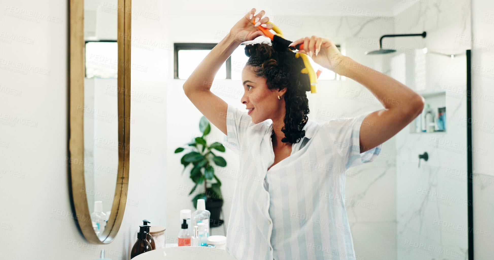 Buy stock photo Bathroom, girl and hair curlers in mirror for getting ready, morning routine and volume locks. Self care, person and happy in home with haircare, grooming and beauty products for heatless hairstyle