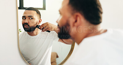 Buy stock photo Man, machine and shaving beard in mirror of bathroom for grooming, clean face and self care routine. Hygiene, reflection and person with electrical razor in home for facial hair trim and skincare
