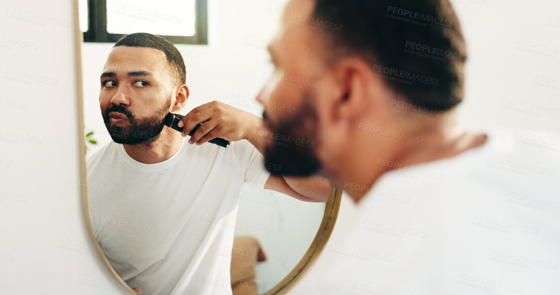Buy stock photo Man, machine and shaving beard in mirror of bathroom for grooming, clean face and self care routine. Hygiene, reflection and person with electrical razor in home for facial hair trim and skincare