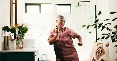 Buy stock photo Dance, energy and senior woman in bathroom for morning, skincare and jade roller routine. Beauty, excited and wellness with happy mature person in apartment for antiaging, dermatology and retirement
