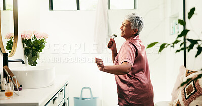 Buy stock photo Dance, energy and senior woman in bathroom for morning, skincare and excited routine. Beauty, jade roller and wellness with happy mature person in apartment for antiaging, dermatology or gua sha