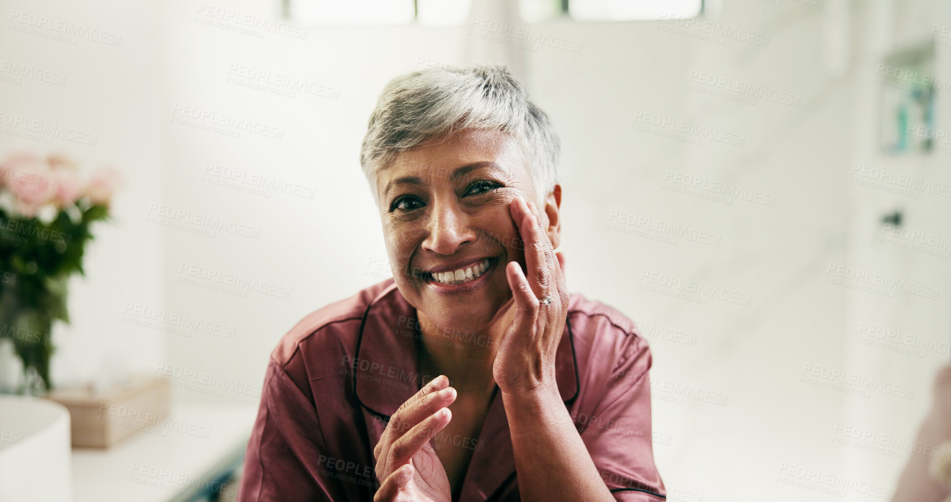 Buy stock photo Portrait, senior woman and skincare in bathroom to check results, facial cosmetics and treatment. Smile, elderly person and touch face for beauty, dermatology progress and hydration benefits at house