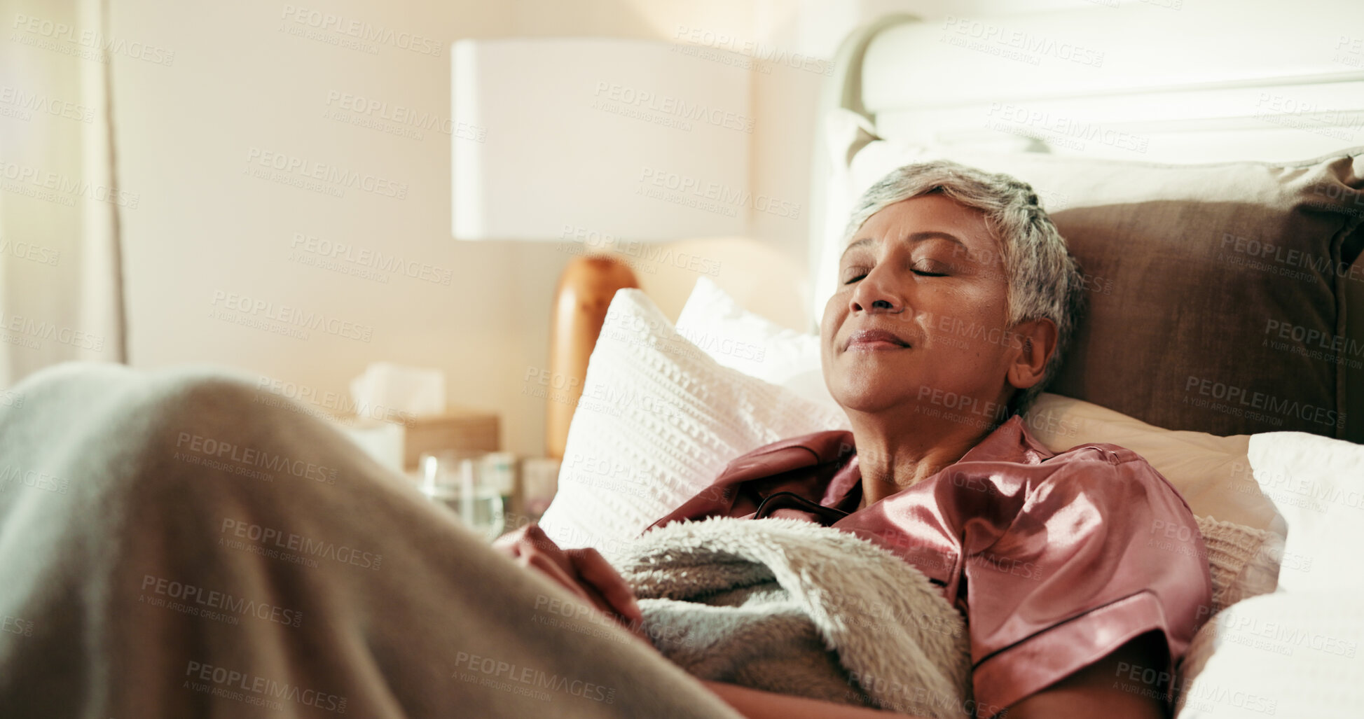 Buy stock photo Sleeping, relax and mature woman on bed with peace, calm and dreaming in bedroom in home. Nap, tired and cozy rest on mattress with fatigue, morning comfort and weekend break for senior person