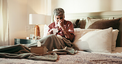 Buy stock photo Senior, sick woman and blowing nose on bed with tissue for influenza or viral infection at home. Female person, virus and cold with flu, sinus or hayfever in bedroom for germs, bacteria or sneeze