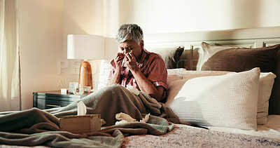 Buy stock photo Mature, sick woman and blowing nose on bed with tissue for influenza or viral infection at home. Female person, virus and cold with flu, sinus or hayfever in bedroom for germs, bacteria or sneeze