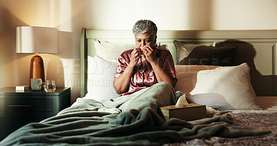 Buy stock photo Mature, sick woman and blowing nose with virus on bed for influenza or viral infection at home. Female person, tissue and cold with flu, sinus or hayfever in bedroom for germs, bacteria or sneeze